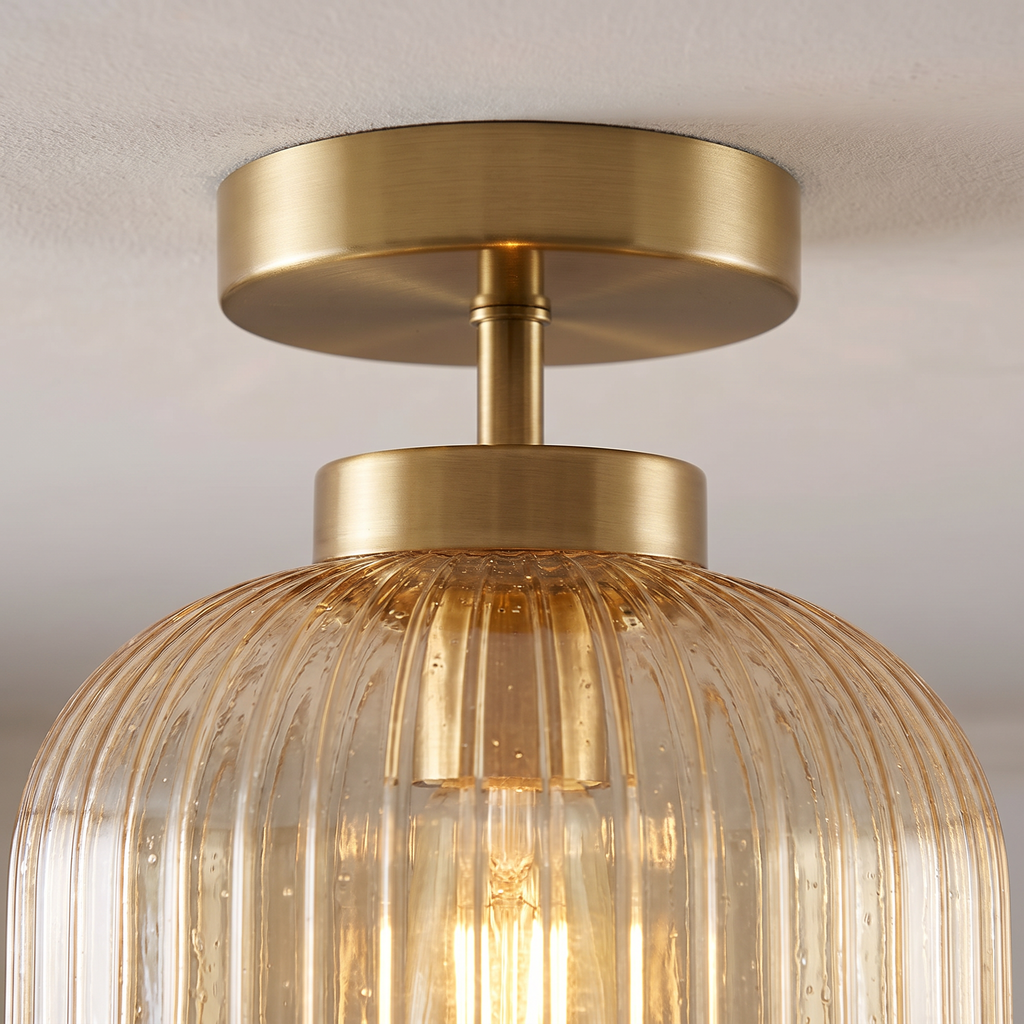 Close up of the brass finish stem and ribbed amber glass