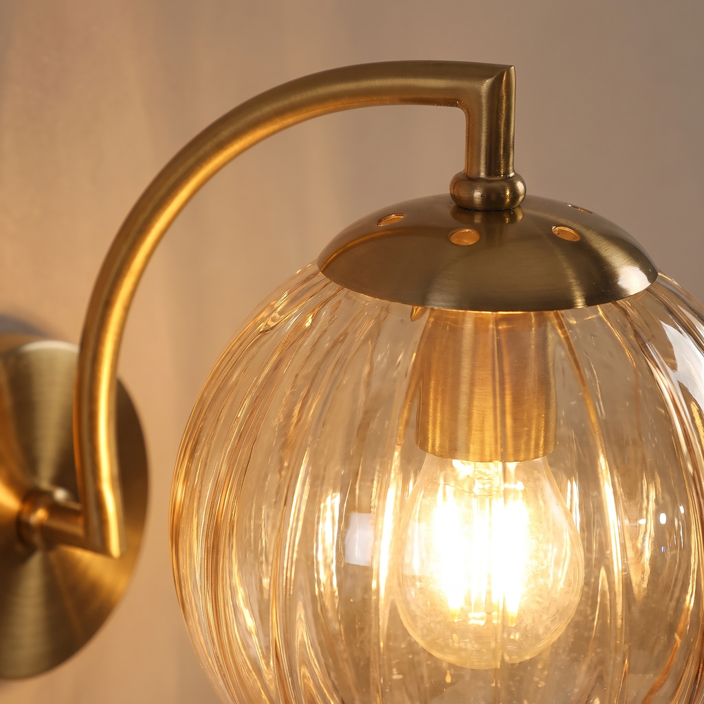 Close up of the ribbed amber glass and brass arm