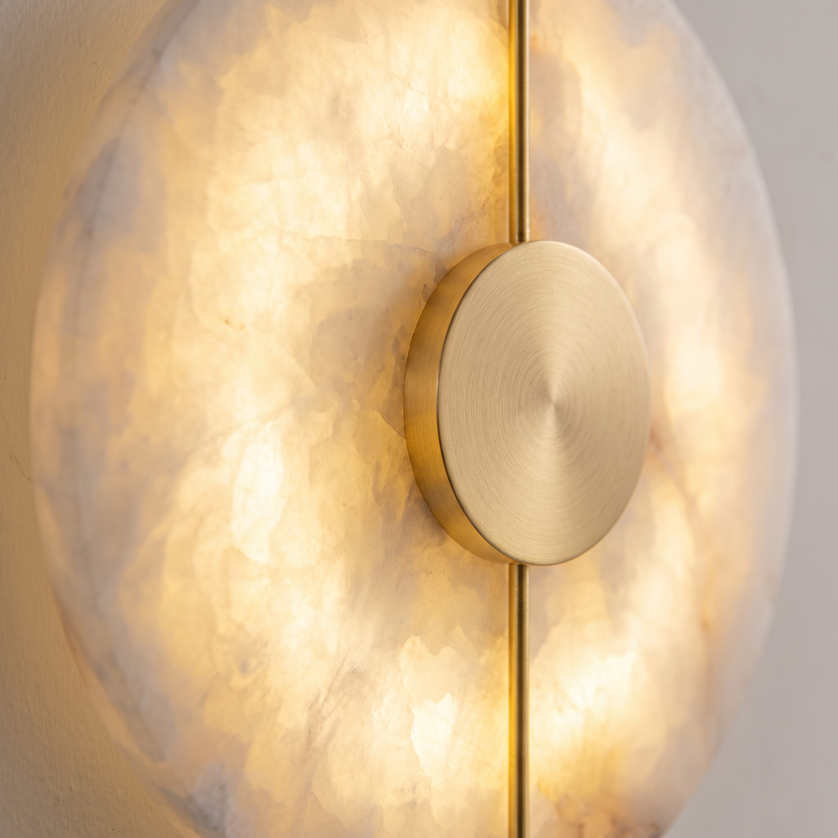 Close up of the glowing alabaster veining and brass centre plate