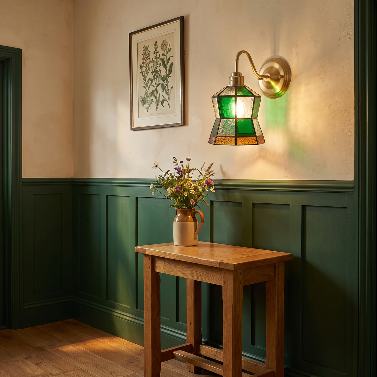 Walberswick stained glass wall light glowing above an oak console table in a green panelled hallway