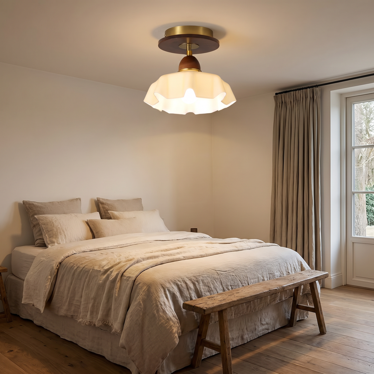 Frosted Blakeney semi flush ceiling light glowing above a bed in a low ceilinged bedroom
