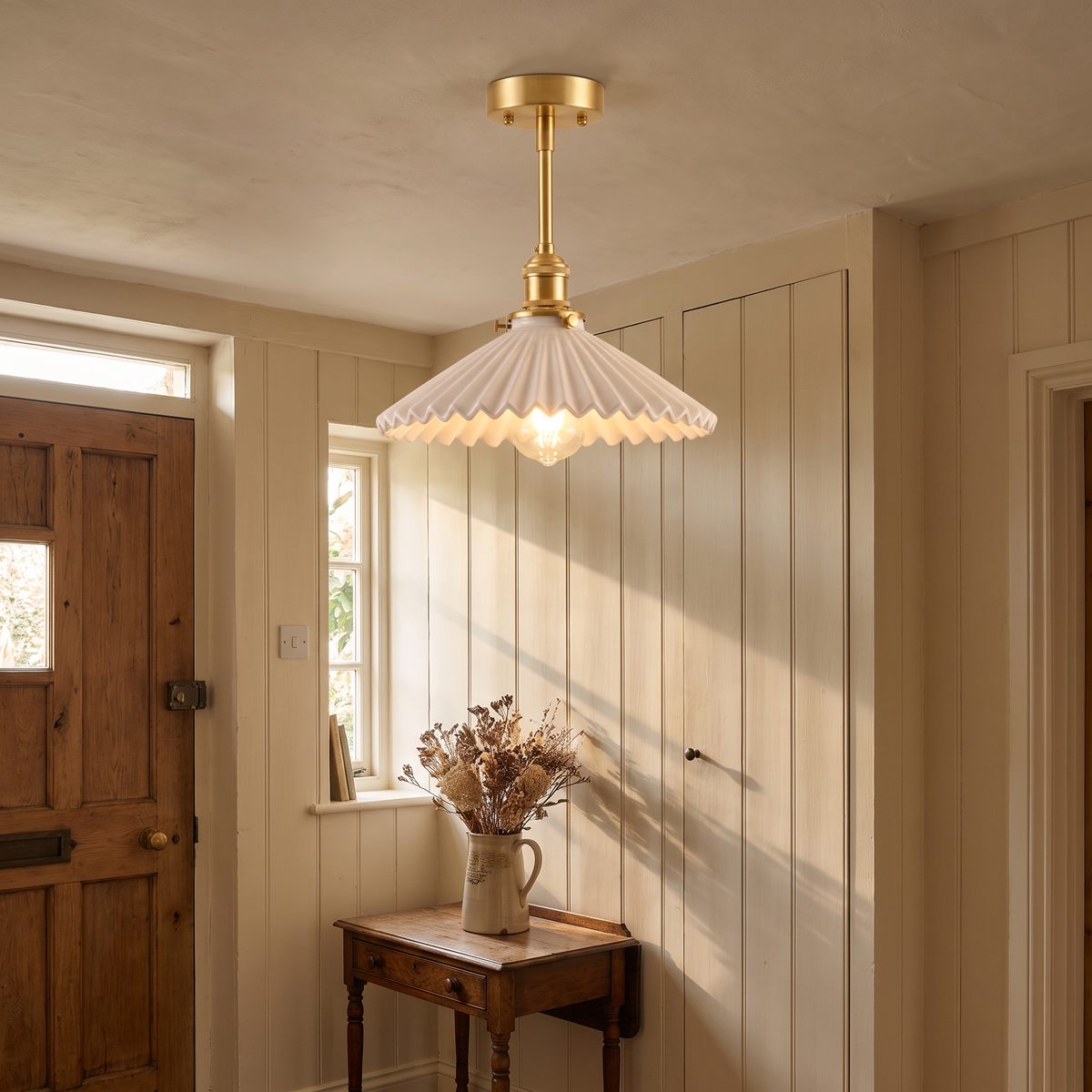 Debenham pleated ceramic ceiling light lit on the low ceiling of a cottage hallway