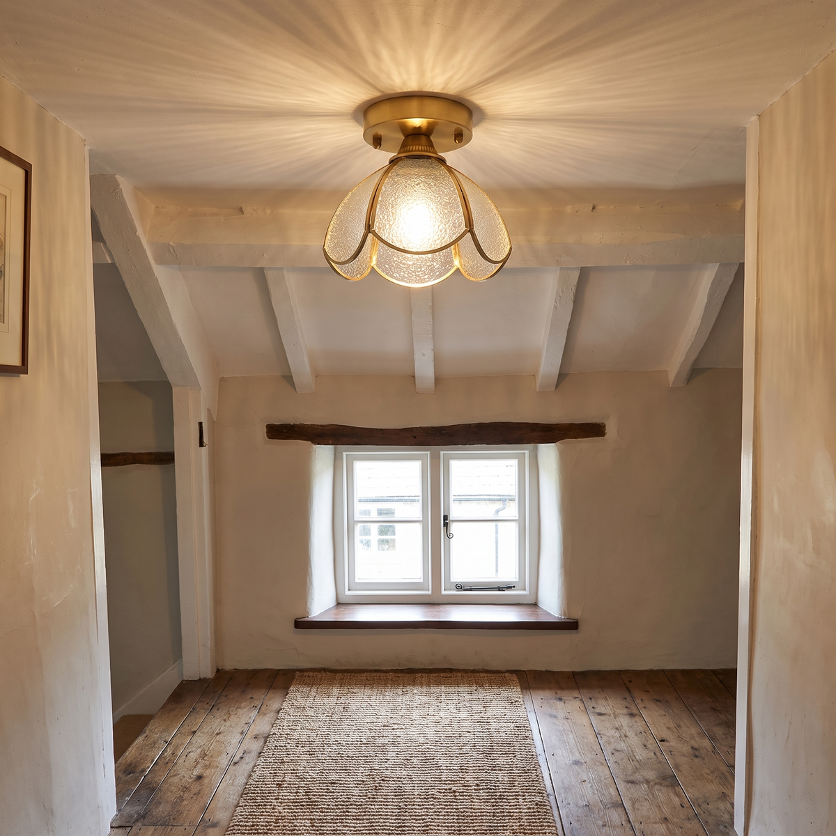 Hadleigh petal glass flush ceiling light lit on the low beamed ceiling of a cottage landing