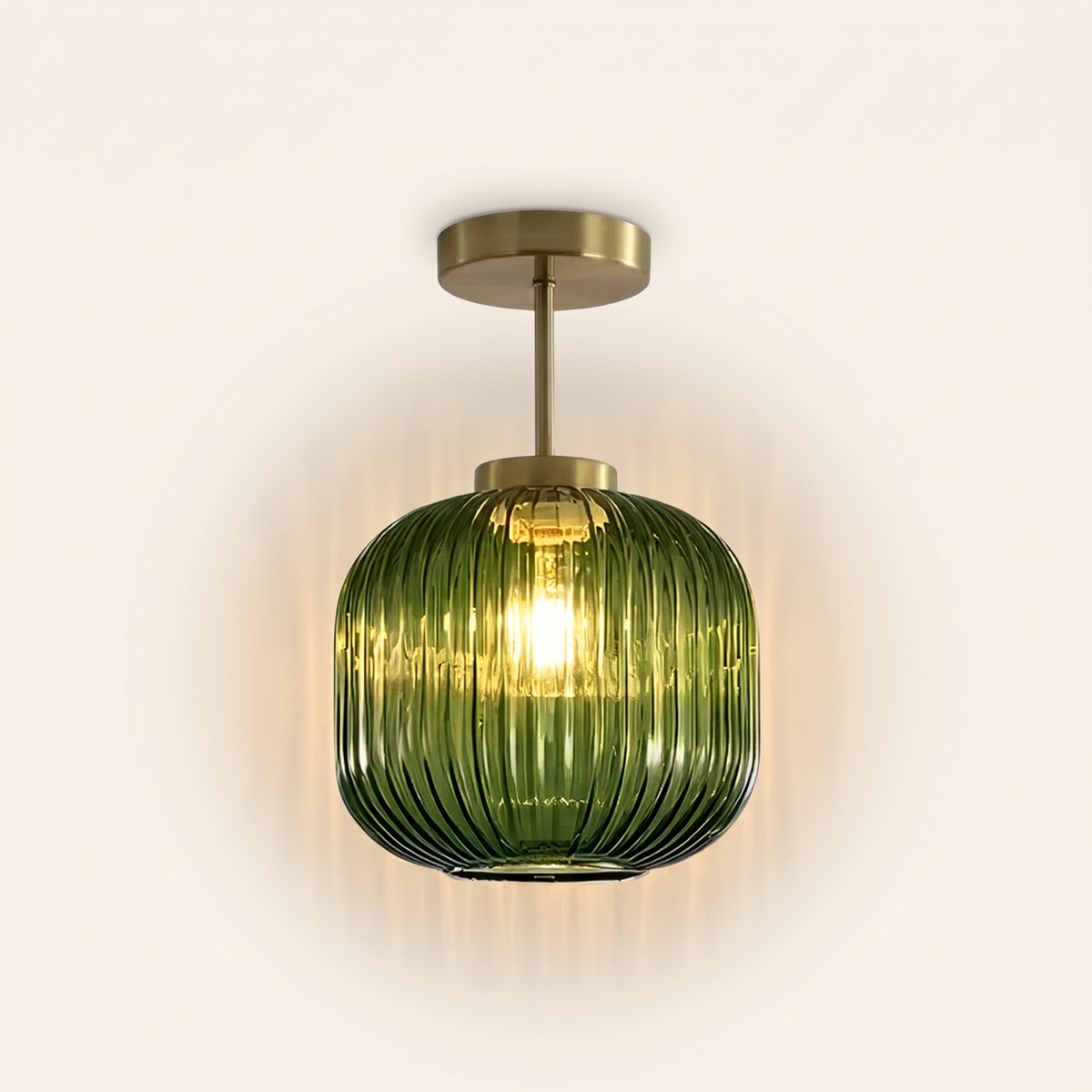 Thornbury ribbed glass semi flush ceiling light in green, lit, on a cream background