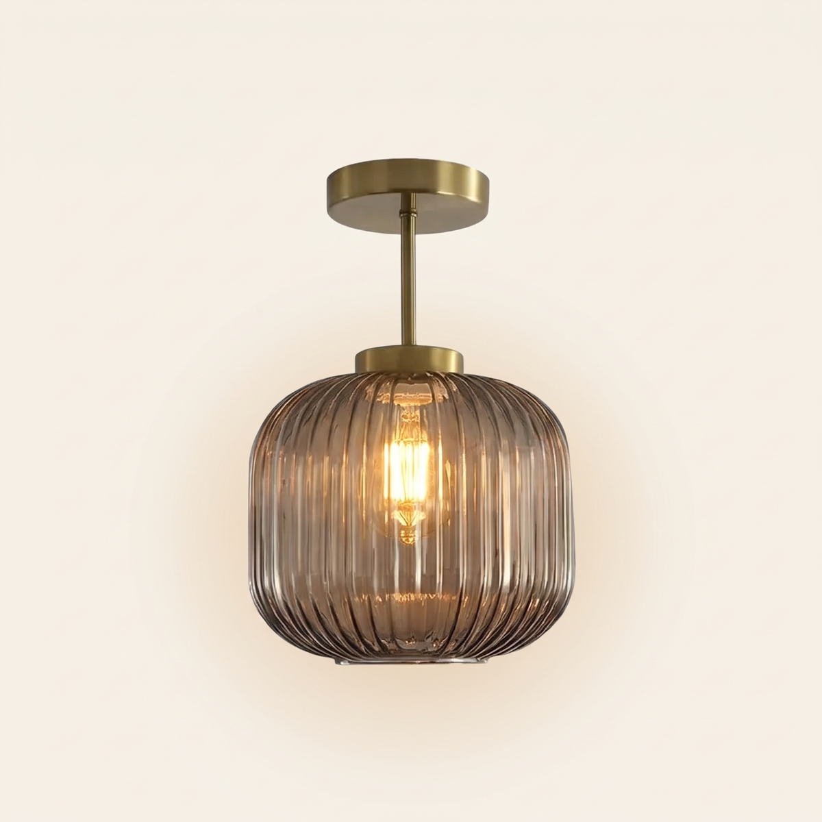 Thornbury ribbed glass semi flush ceiling light in smoked grey, lit, on a cream background