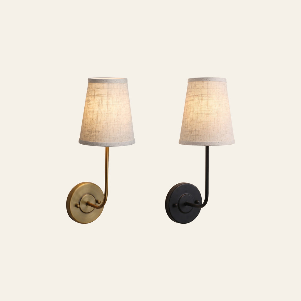 The Hintlesham wall light in antique brass and in black side by side