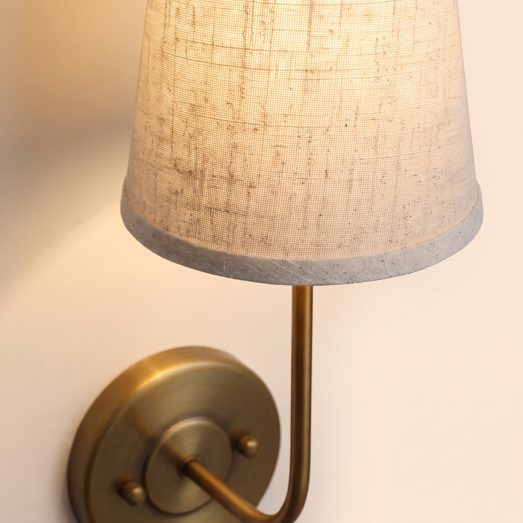 Close up of the Hintlesham linen shade and antique brass stem, lit