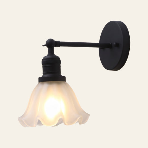 Hoxne wall light with a ruffled frosted glass tulip shade on a swivel arm and round wall plate in black, cream background