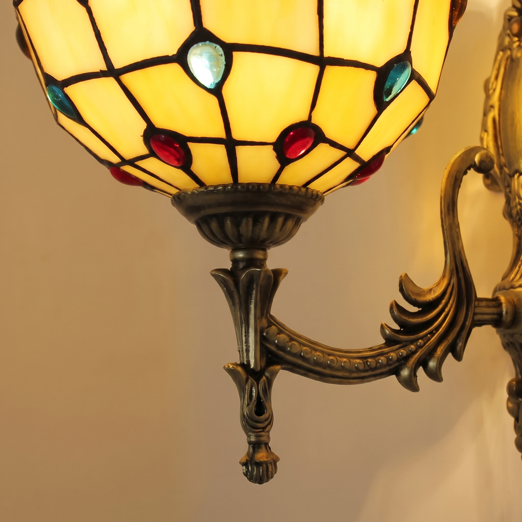 Close up of the amber Kentwell shade showing the glass jewels set into the leading, glowing warm