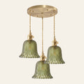 Lavenham 3 light cluster pendant with three green cut glass bells on a round brass ceiling plate, cream background
