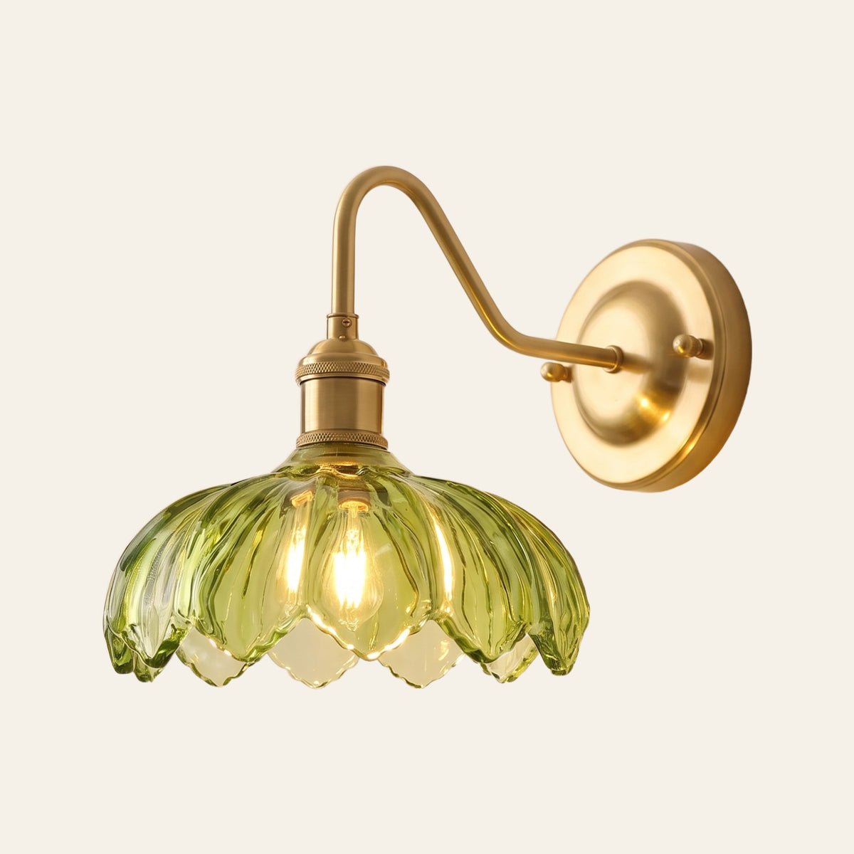 Laxfield wall light with a green ribbed scalloped glass shade on a brass swan neck arm, lit