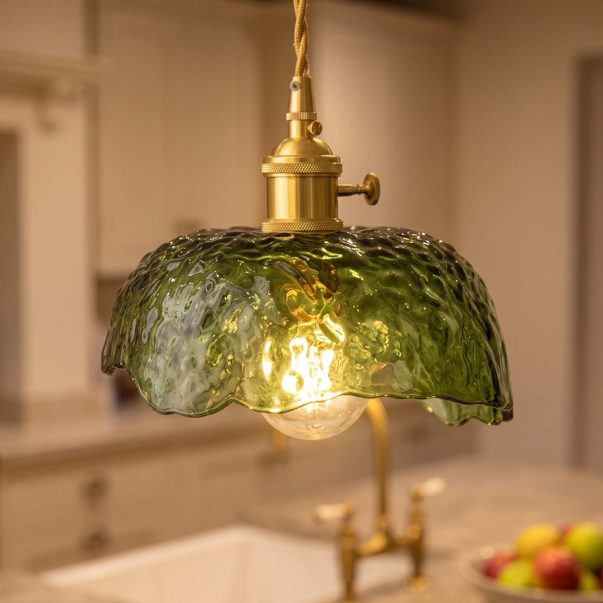 Close up of a lit Linstead shade showing the dimpled green glass and wavy rim
