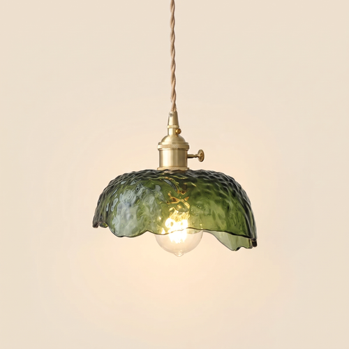 Linstead pendant light with a green textured glass bowl and wavy rim on a brass holder, cream background