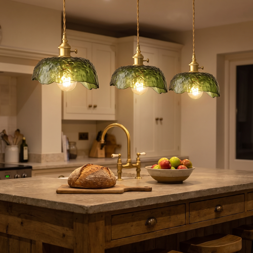 Three lit Linstead green textured glass pendants over a kitchen island