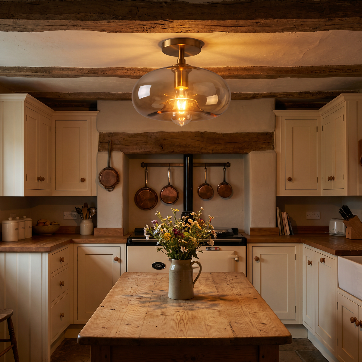 A lit Mendham amber glass ceiling light between the beams of a cottage kitchen above a wooden table