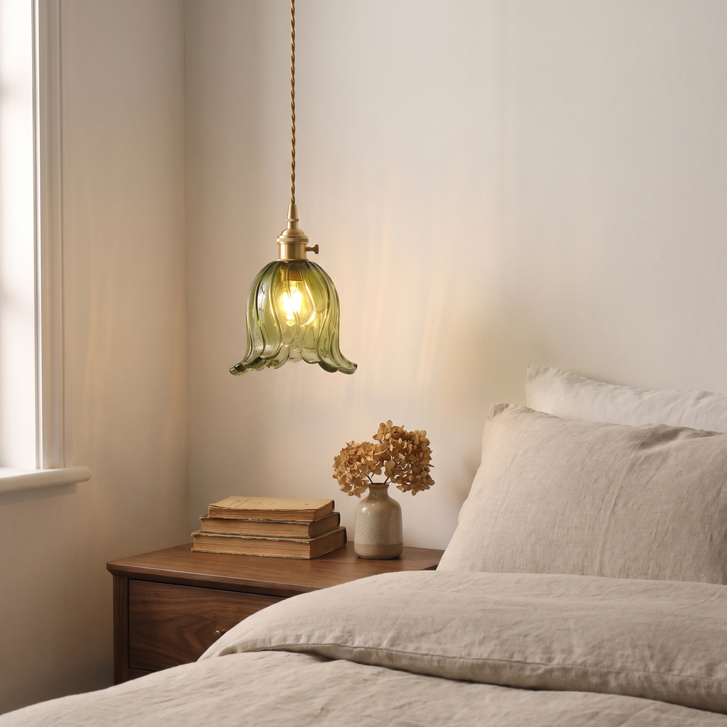 Green Metfield tulip pendant hung low beside a bed over a walnut bedside table