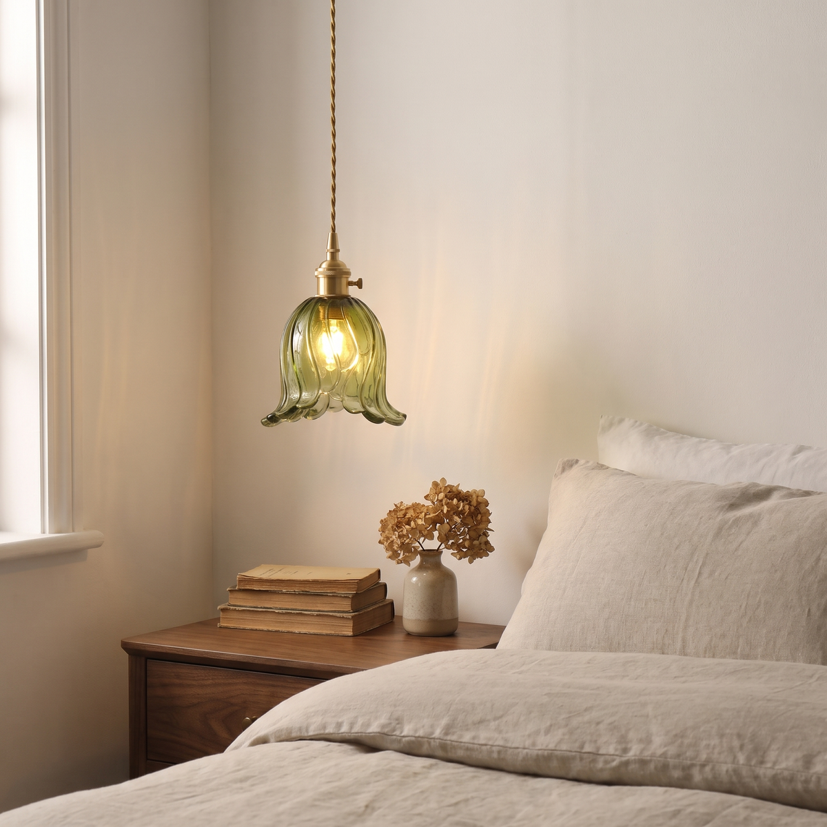 Green Metfield tulip pendant hung low beside a bed over a walnut bedside table