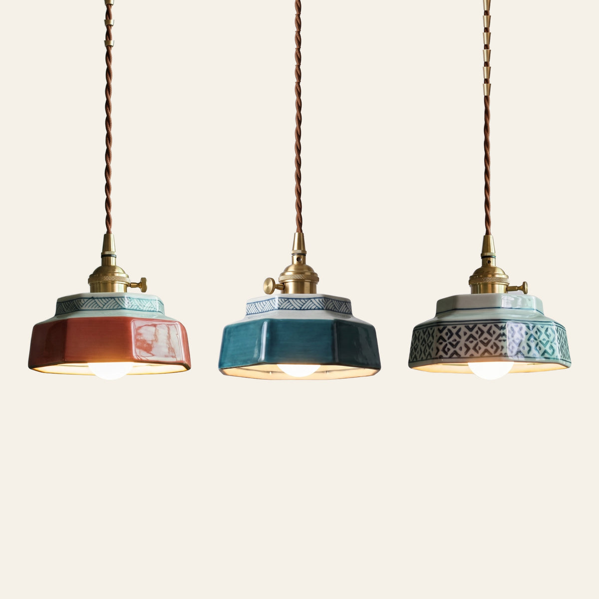 The Mettingham pendant light in coral red, teal and celadon diamond side by side