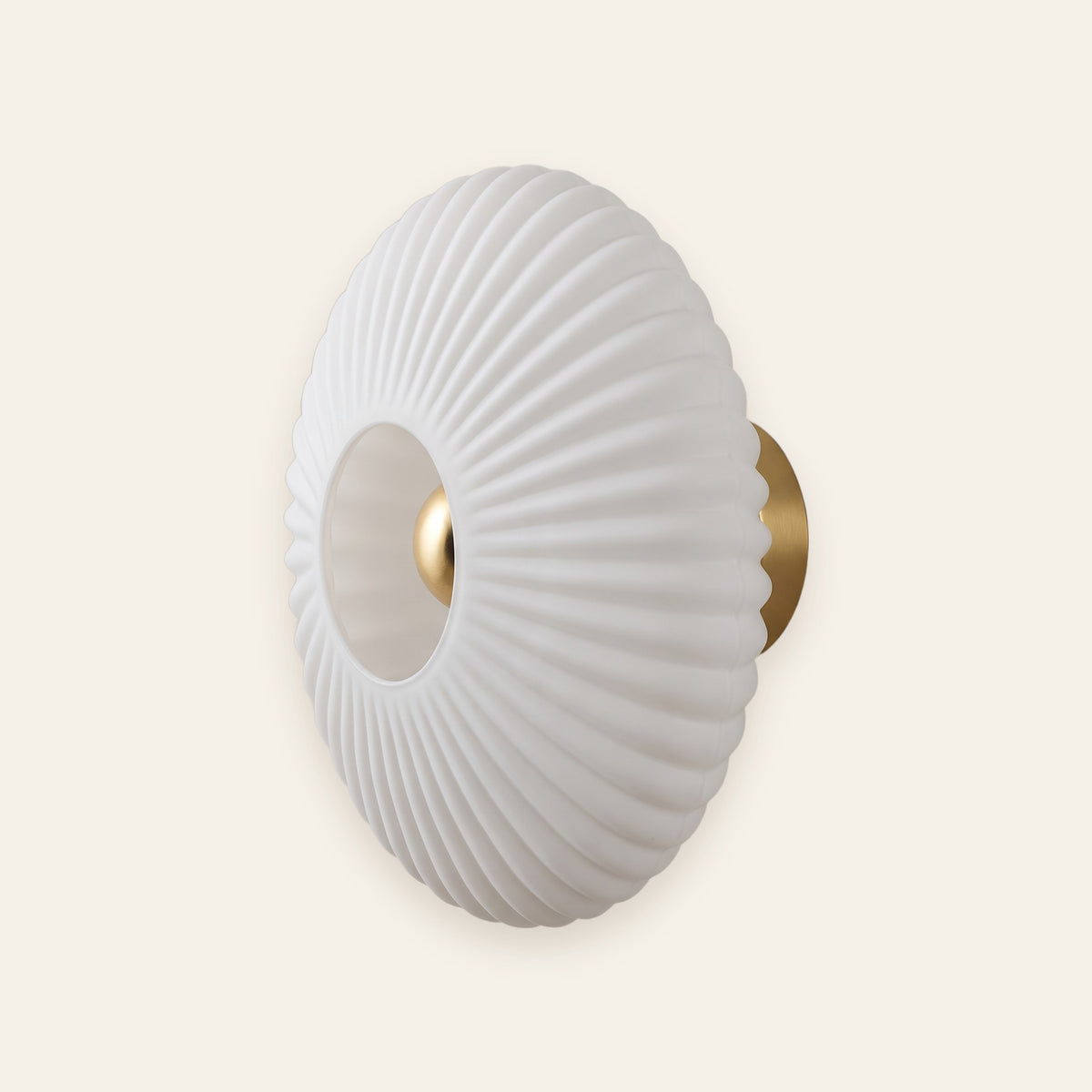 Ondine pleated opal glass wall light with brass plate, cream background