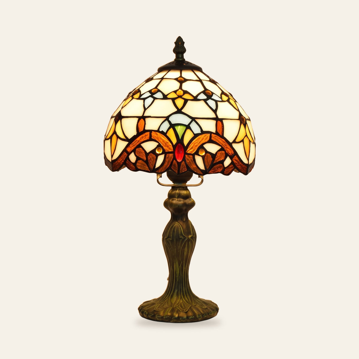 Polstead stained glass table lamp with a cream leaded shade and an amber and burgundy baroque band on a bronze finish base, cream background