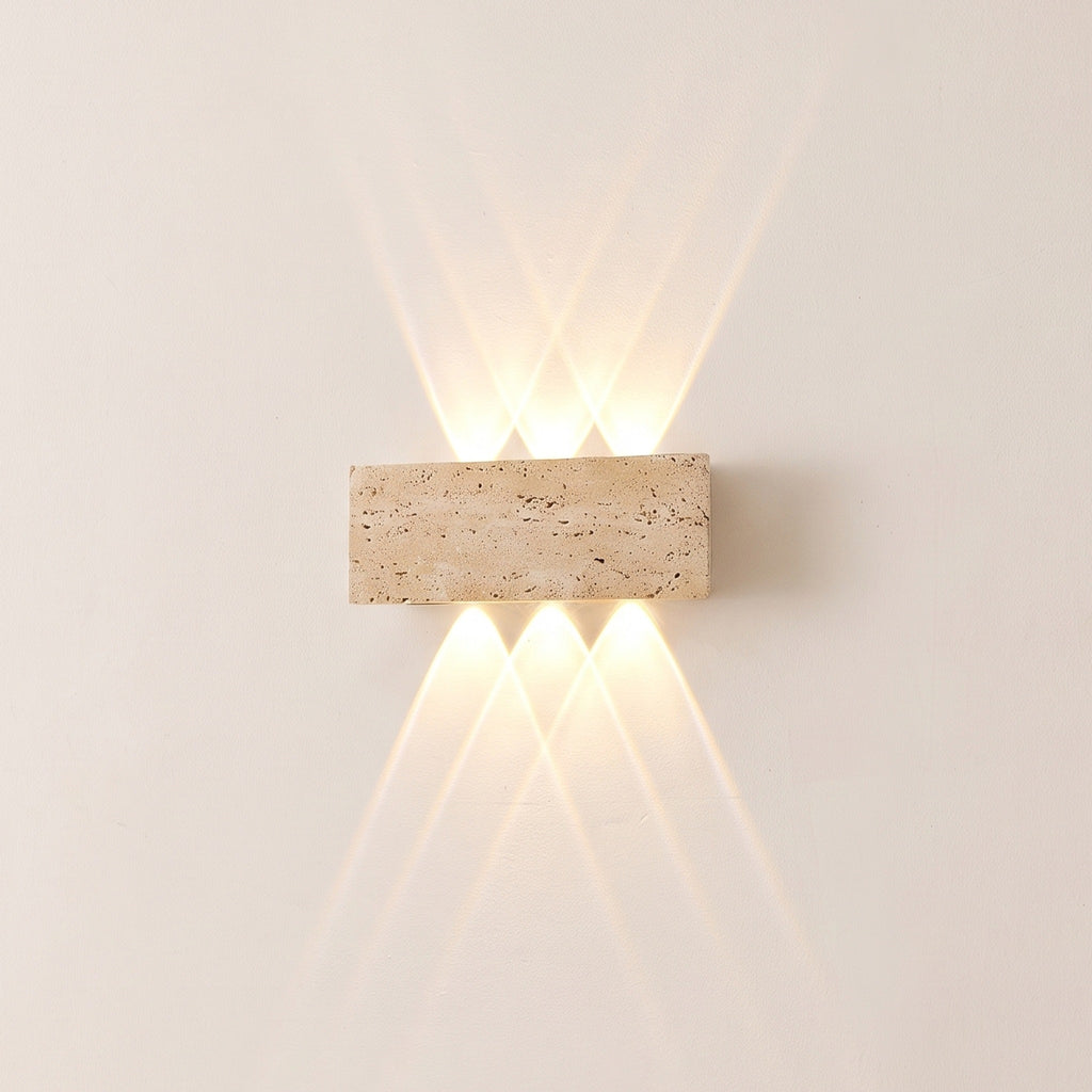 Purbeck travertine up and down wall light switched on, warm light fanning up and down a cream wall
