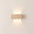 Purbeck travertine up and down wall light switched on, warm light fanning up and down a cream wall