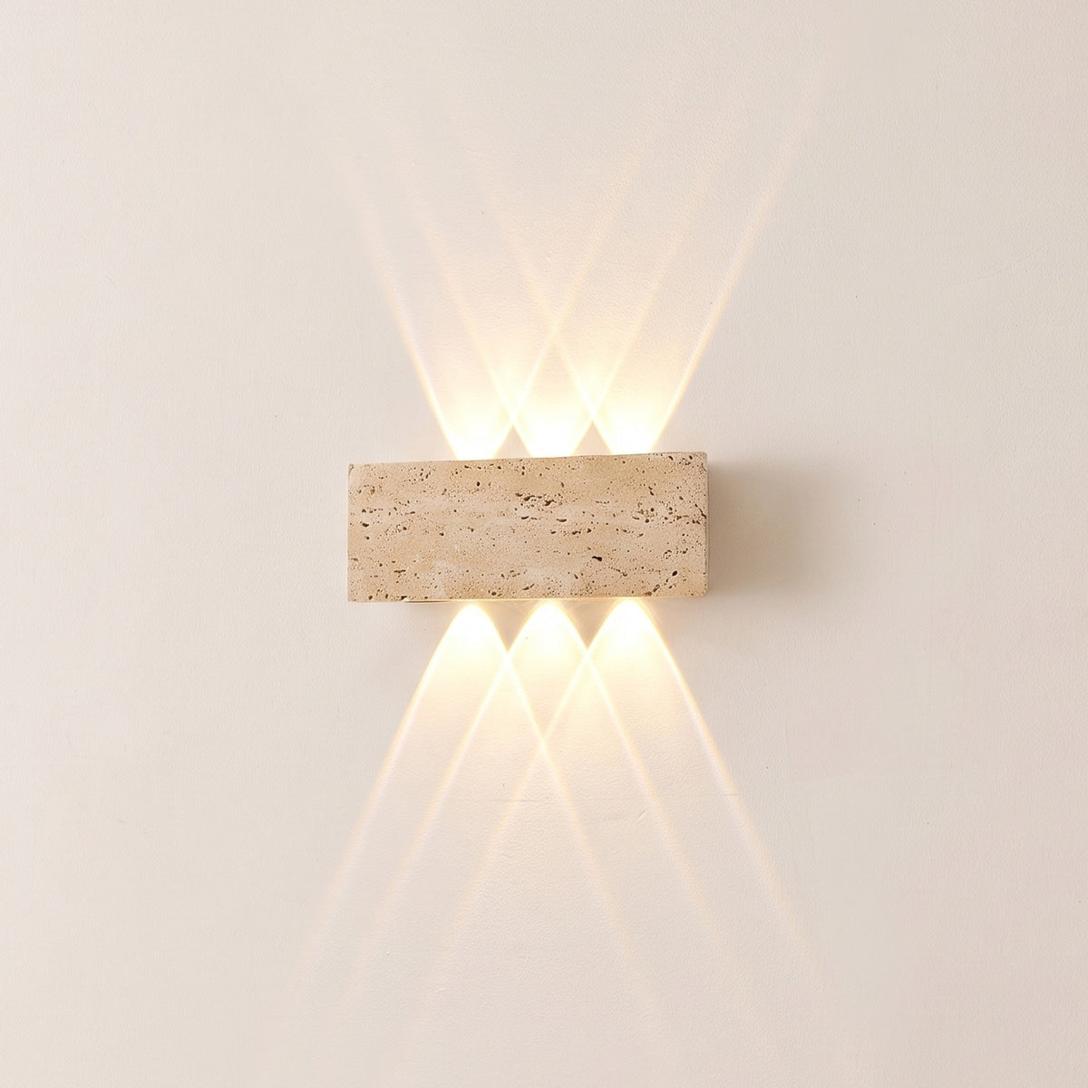 Purbeck travertine up and down wall light switched on, warm light fanning up and down a cream wall