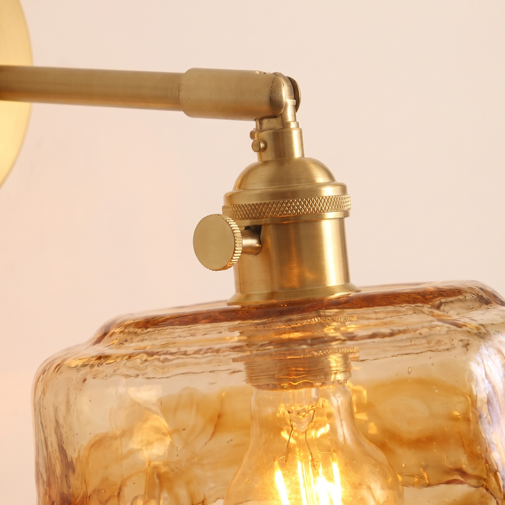 Close up of the Redgrave amber hammered glass and the knurled lamp holder with its turn knob, lit