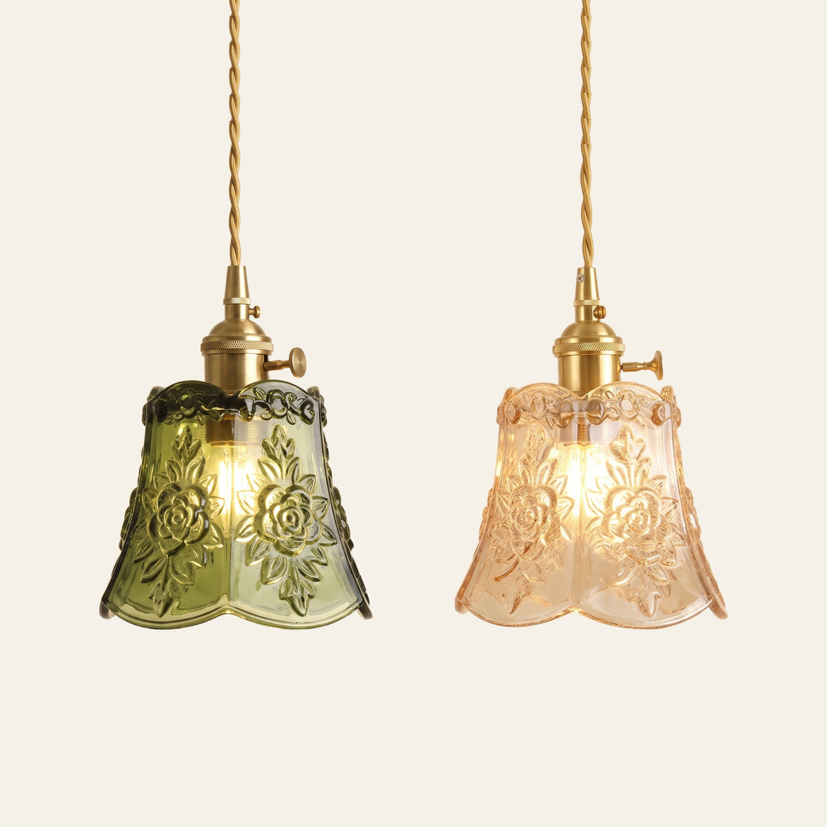 Rendham rose glass pendant lights in green and amber side by side