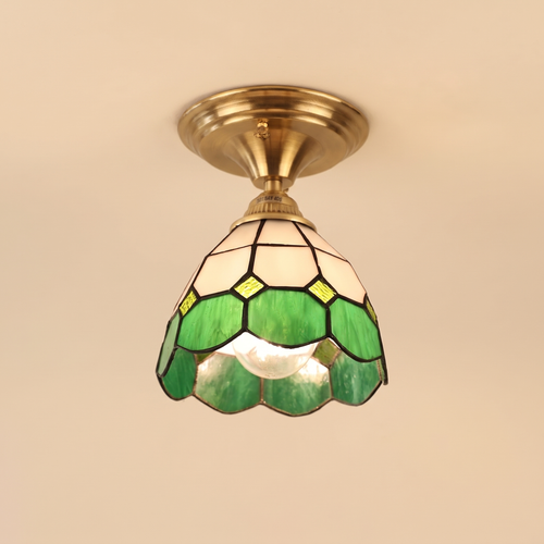Theberton stained glass ceiling light with white and green leaded glass and a scalloped rim on an antique brass canopy, cream background