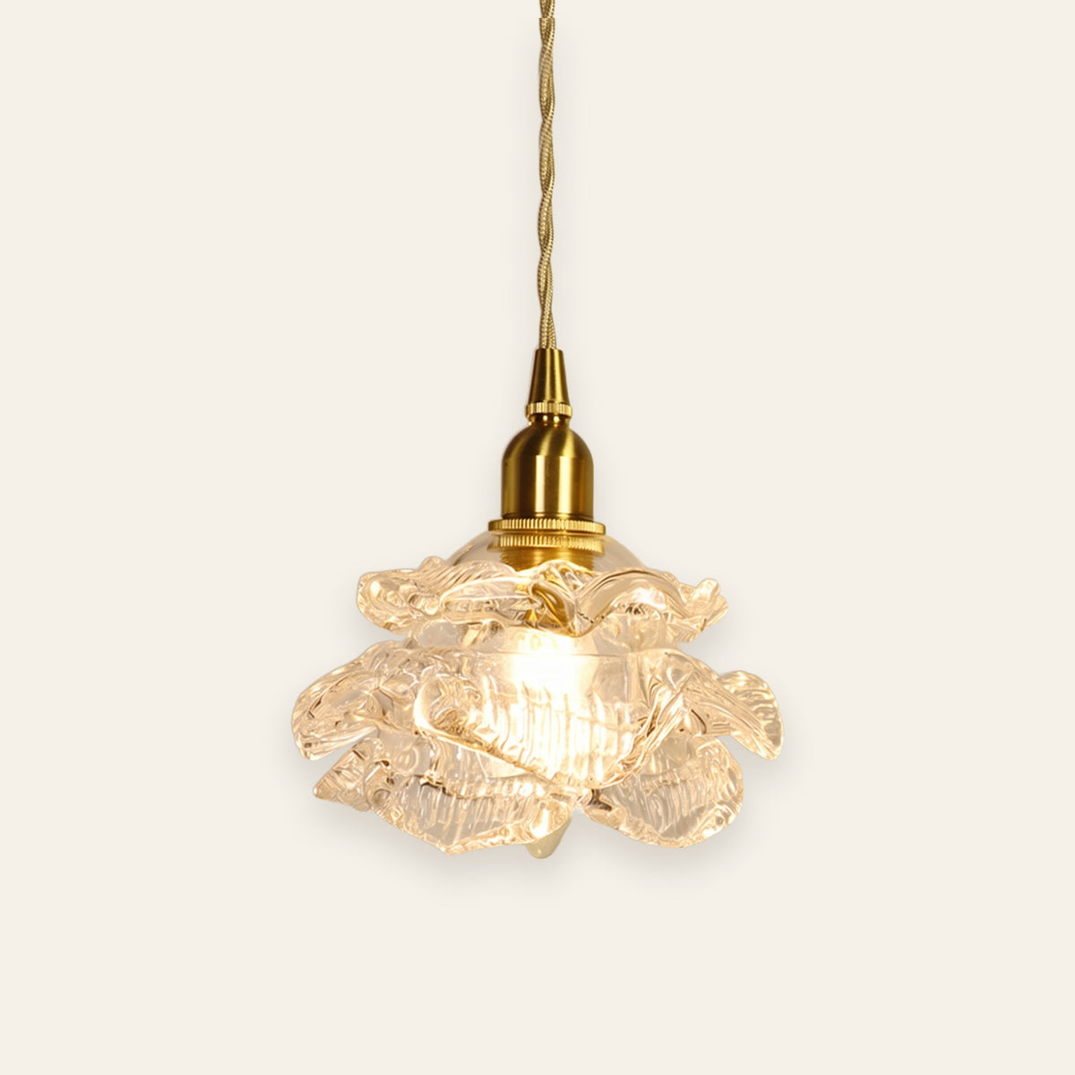 Thorpeness rose glass pendant light in clear glass on a brass finish holder, lit