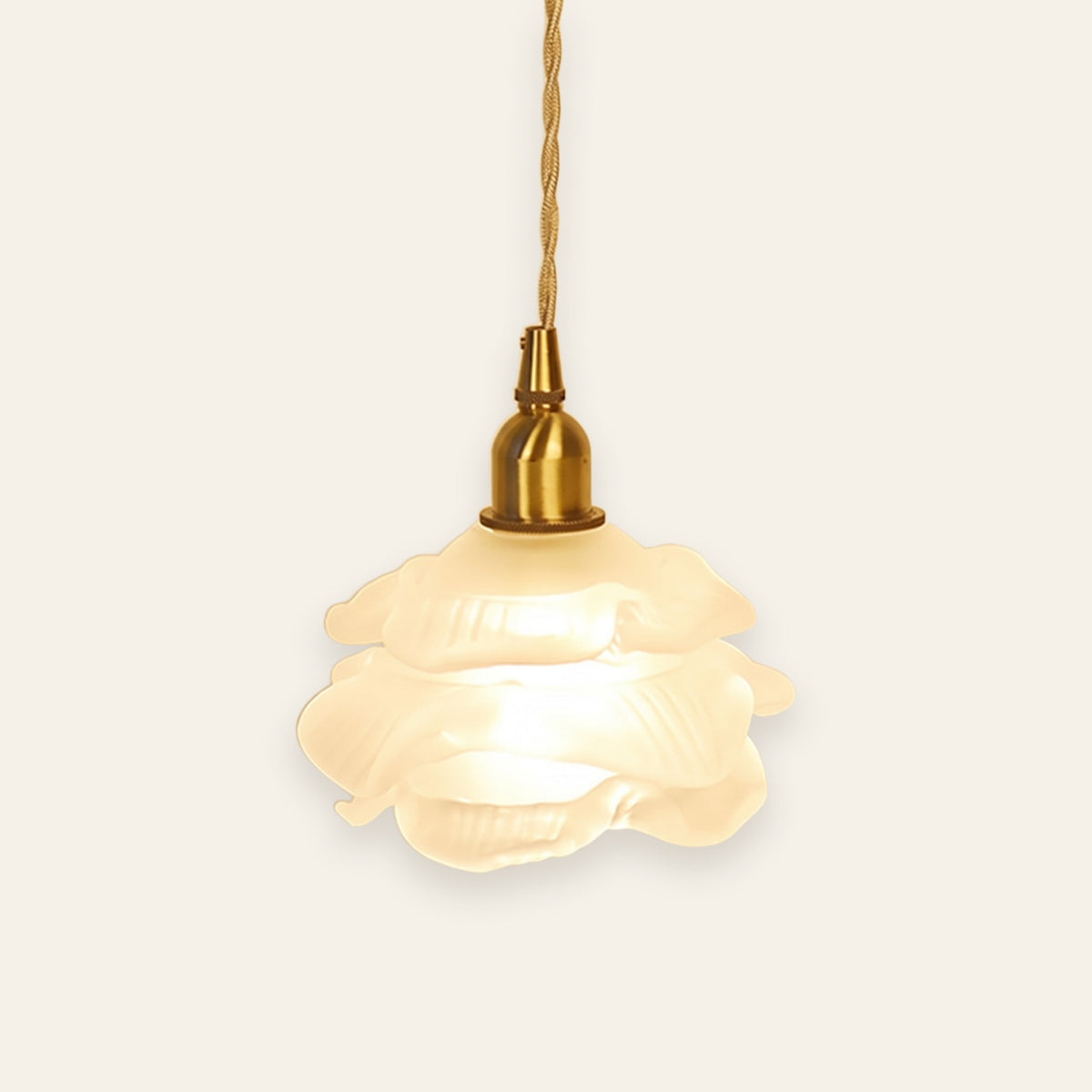 Thorpeness rose glass pendant light in frosted glass on a brass finish holder, lit