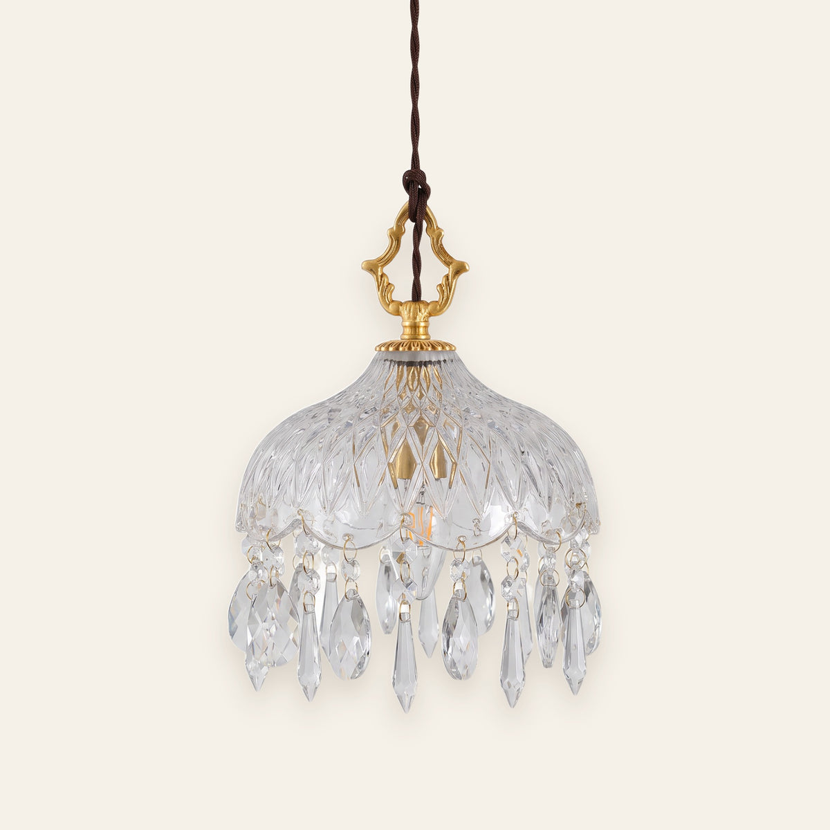 Valmont crystal glass pendant with crystal drops on a cream background