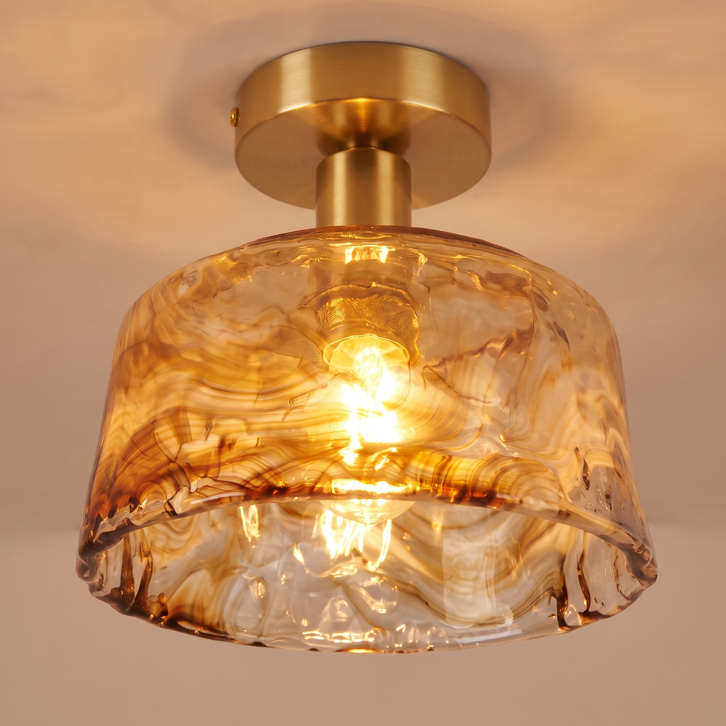 Close up of a lit Walpole shade showing the swirls of marbled amber glass