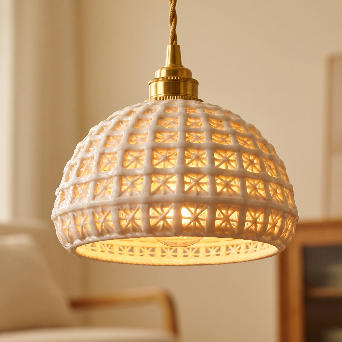 Close up of a lit Wangford shade showing the basket weave lattice and brass finish holder
