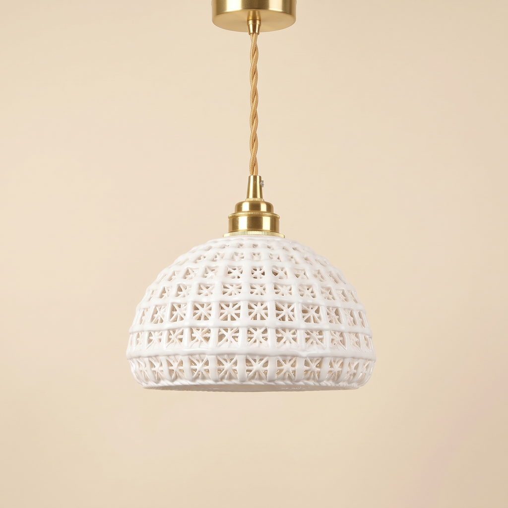 Wangford pendant light with a white ceramic basket weave dome on a brass finish holder and twisted gold cord, cream background
