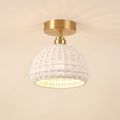 Wangford semi flush ceiling light with a white ceramic basket weave dome on a short brass fitting, cream background