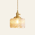 Wenhaston ribbed glass pendant light in amber with a brass switch holder and twisted cord, cream background