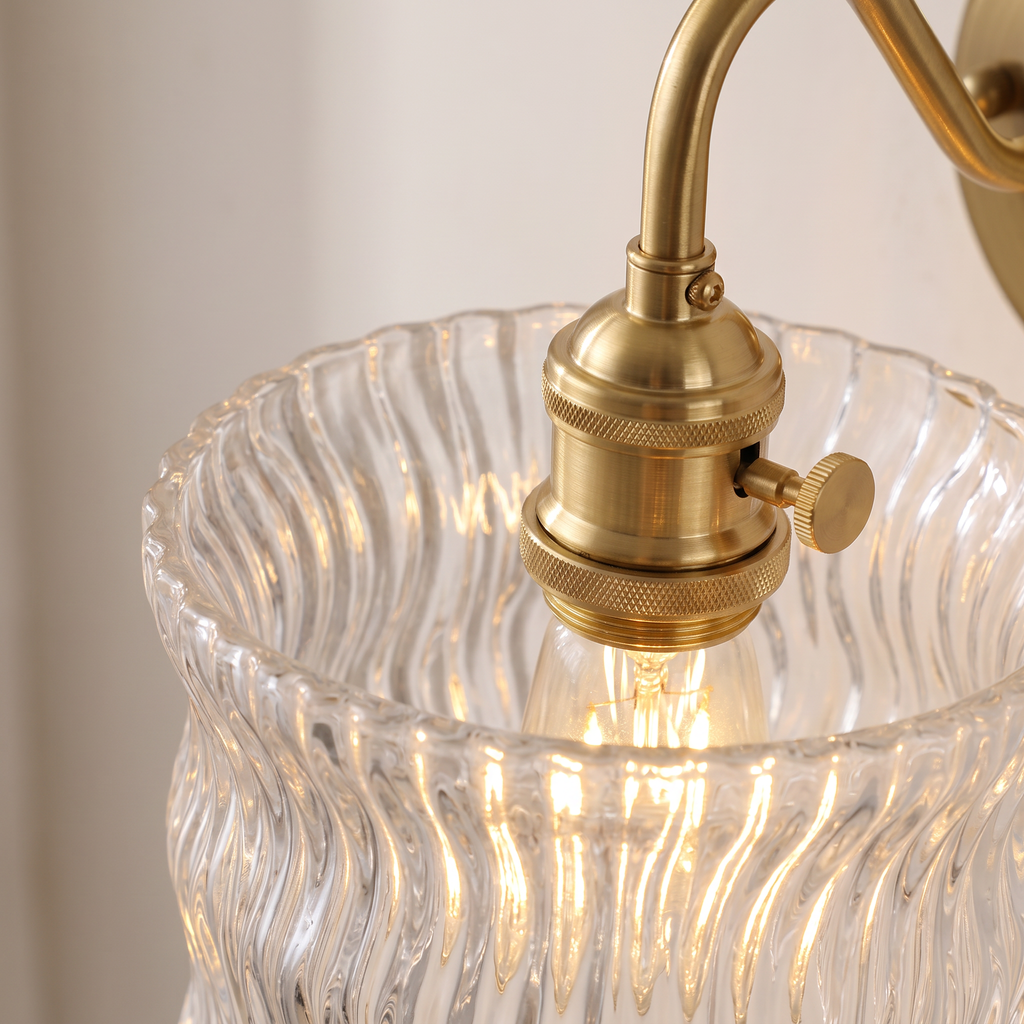 Close up of the Westleton clear rippled glass drum shade, brass holder and turn knob switch