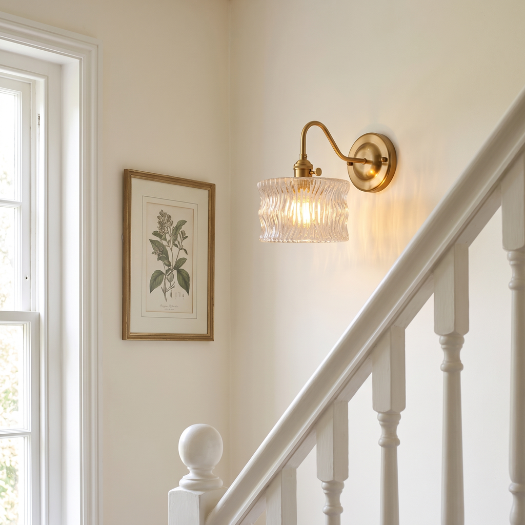 Westleton ripple glass wall light on a stair landing beside a white banister