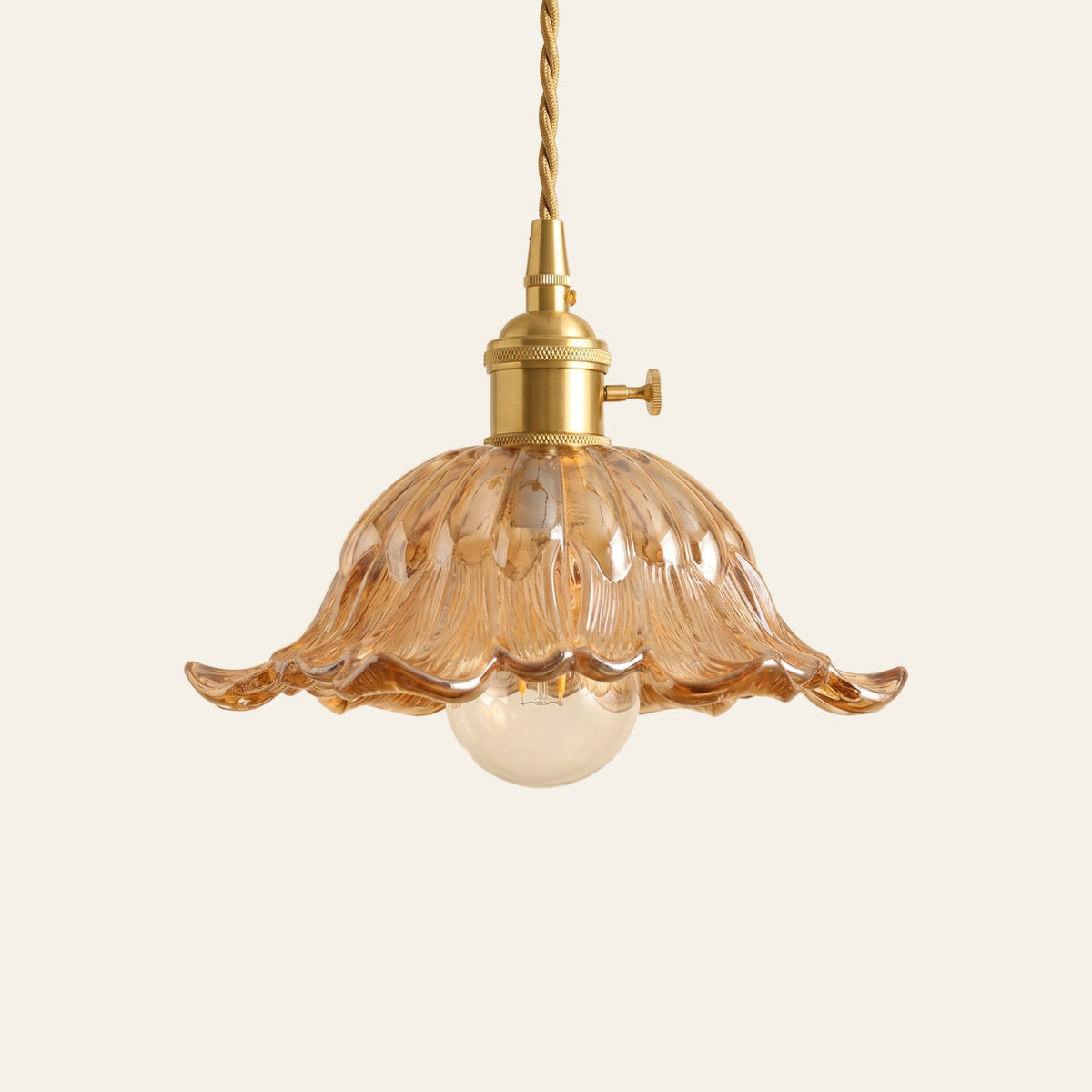 Wissett flower glass pendant light in amber, cream background