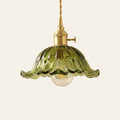 Wissett flower glass pendant light in green with a ruffled petal rim and brass switch holder, cream background