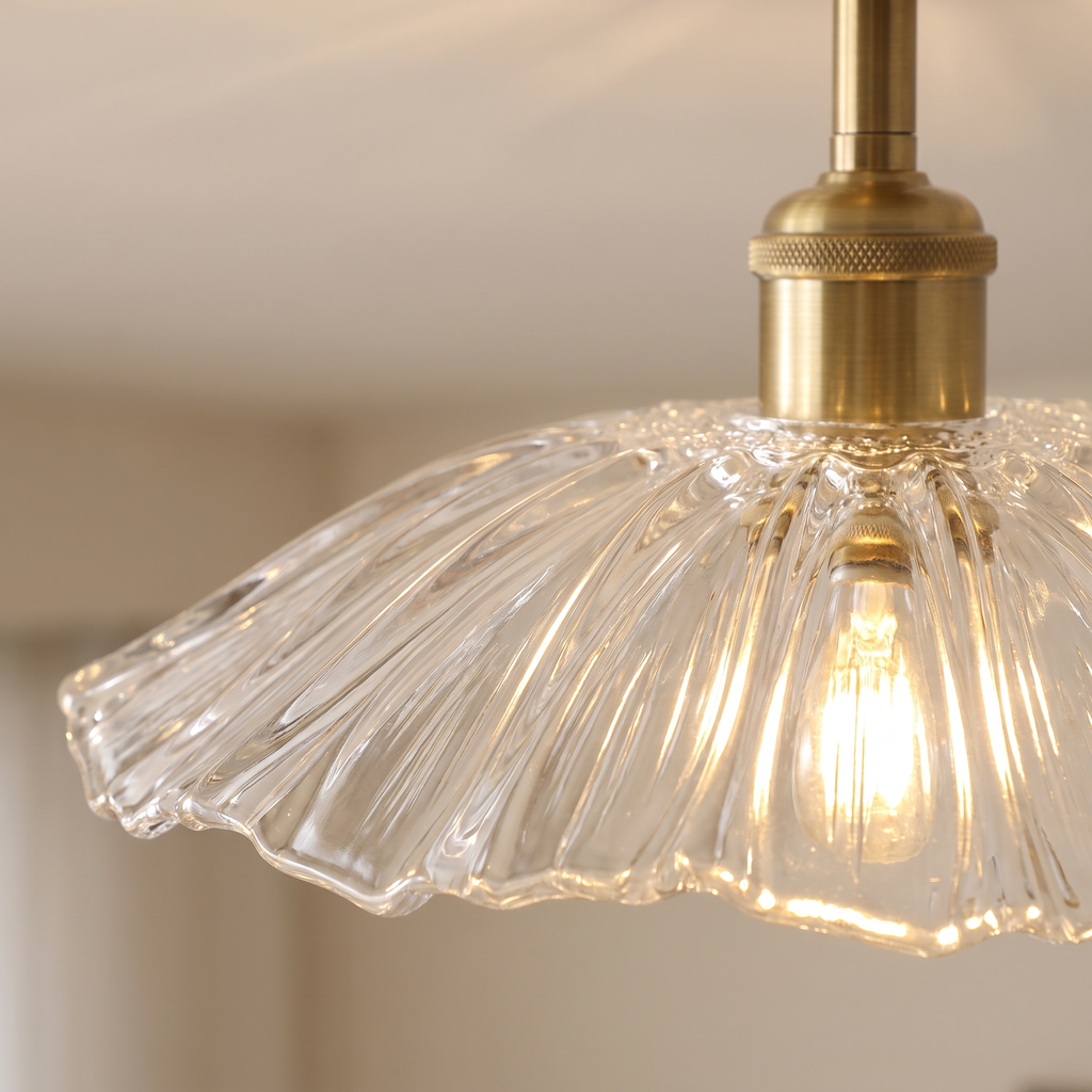 Close up of the Woodbridge clear fluted glass saucer shade and brass rod