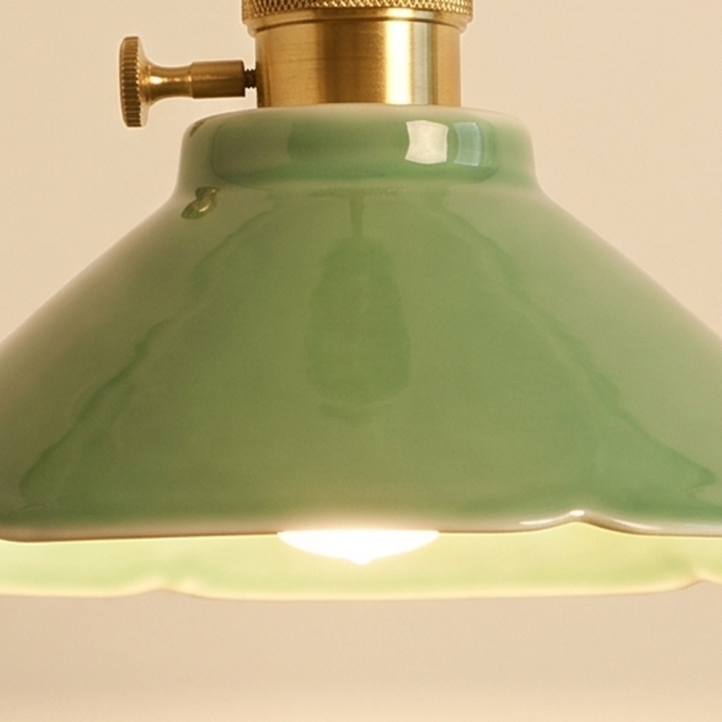 Close up of the glossy jade green glaze of the Wortham shade and its brass holder