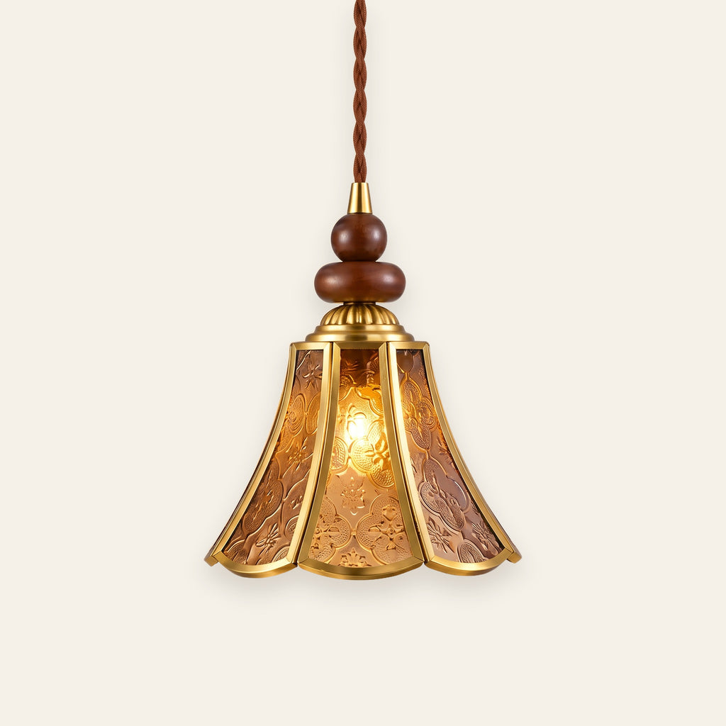 Yoxford pendant light with an amber embossed glass tulip shade, brass tone ribs and walnut tone wood beads, lit