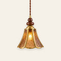 Yoxford pendant light with an amber embossed glass tulip shade, brass tone ribs and walnut tone wood beads, lit